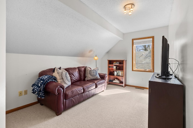 carpeted living area with a textured ceiling, visible vents, baseboards, and lofted ceiling