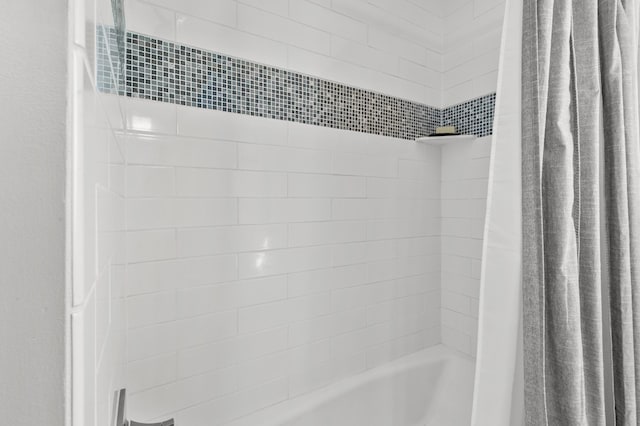 bathroom with shower / bathtub combination with curtain