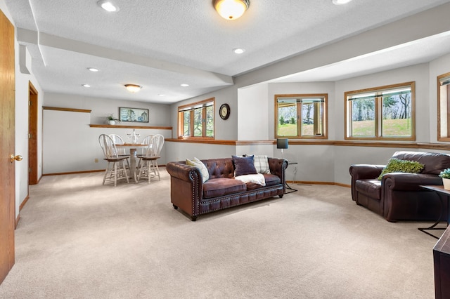 living room with baseboards, carpet flooring, a textured ceiling, and recessed lighting