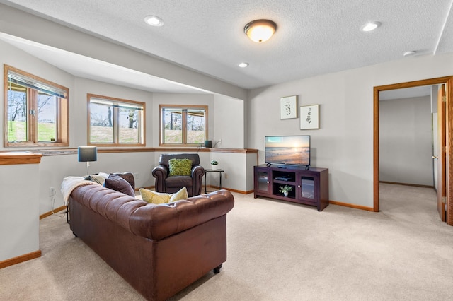 carpeted living area featuring a healthy amount of sunlight, baseboards, recessed lighting, and a textured ceiling