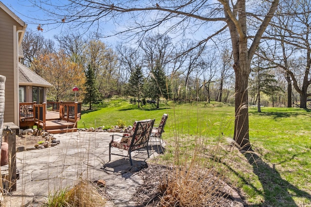 view of yard featuring a deck and a patio area