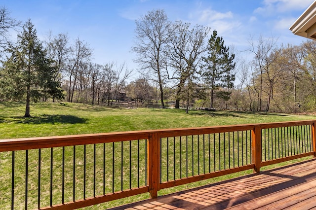 wooden terrace featuring a yard