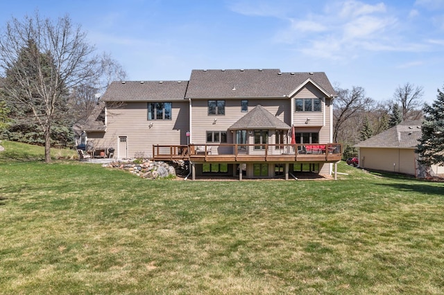 rear view of property featuring a yard and a wooden deck