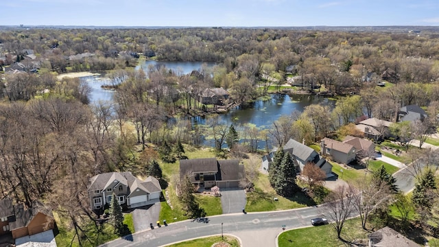 aerial view featuring a water view, a view of trees, and a residential view