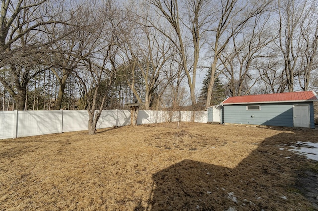 view of yard featuring an outdoor structure and fence private yard