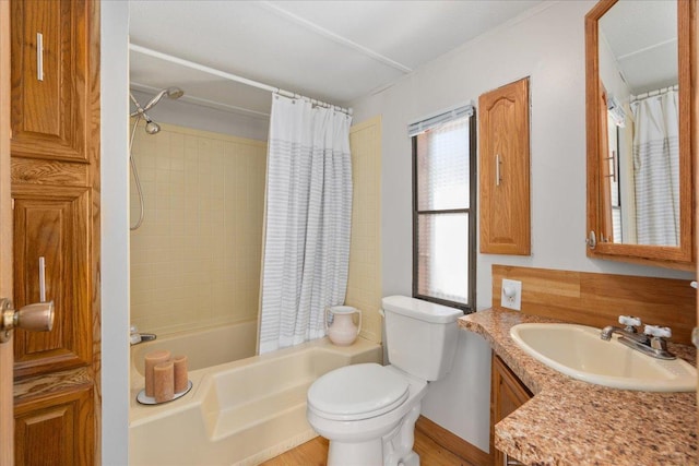 full bath featuring toilet, shower / tub combo with curtain, and vanity