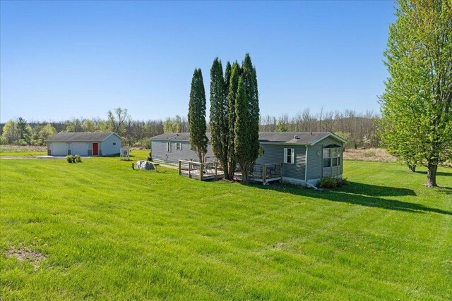 E4970 865th Ave, Sherman Twp, WI 54725 - view of green lawn featuring a detached garage and a wooden deck