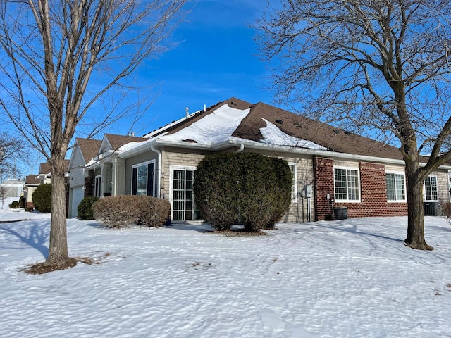 view of front of property with brick siding and an attached garage