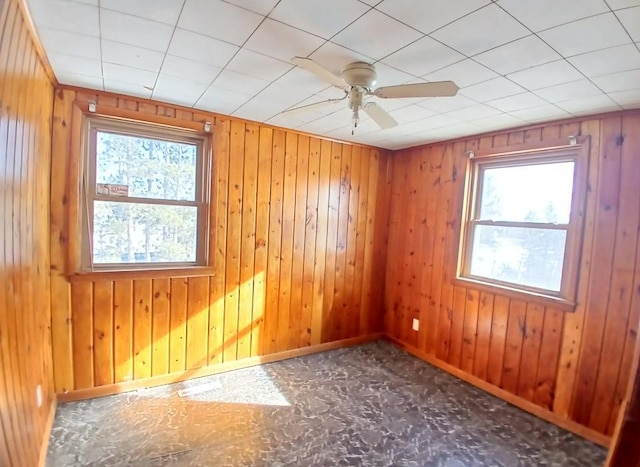 3285 Vermilion Trl, Colvin Twp, MN 55763 - unfurnished room with healthy amount of natural light, a ceiling fan, baseboards, and wood walls