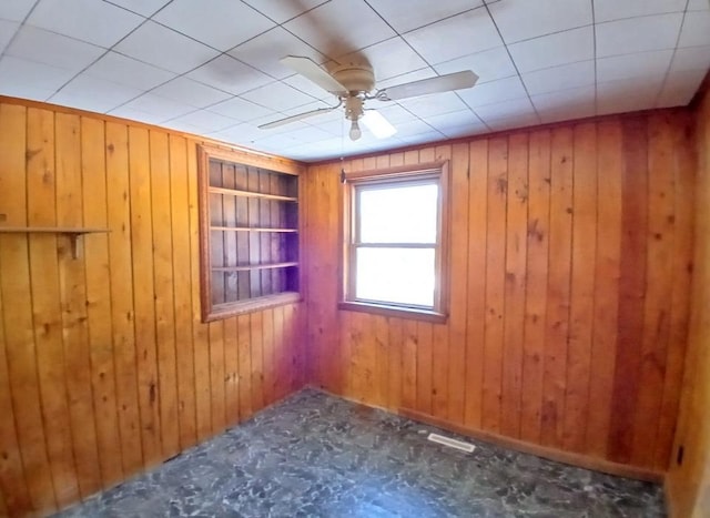 3285 Vermilion Trl, Colvin Twp, MN 55763 - spare room with built in features, ceiling fan, and wood walls