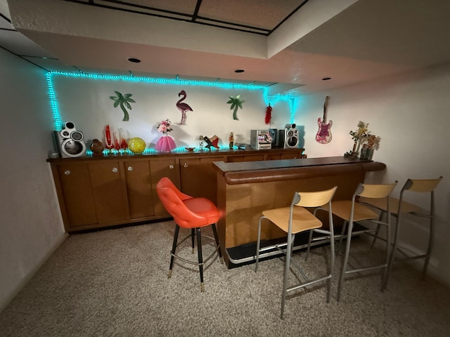 bar featuring carpet floors and a dry bar