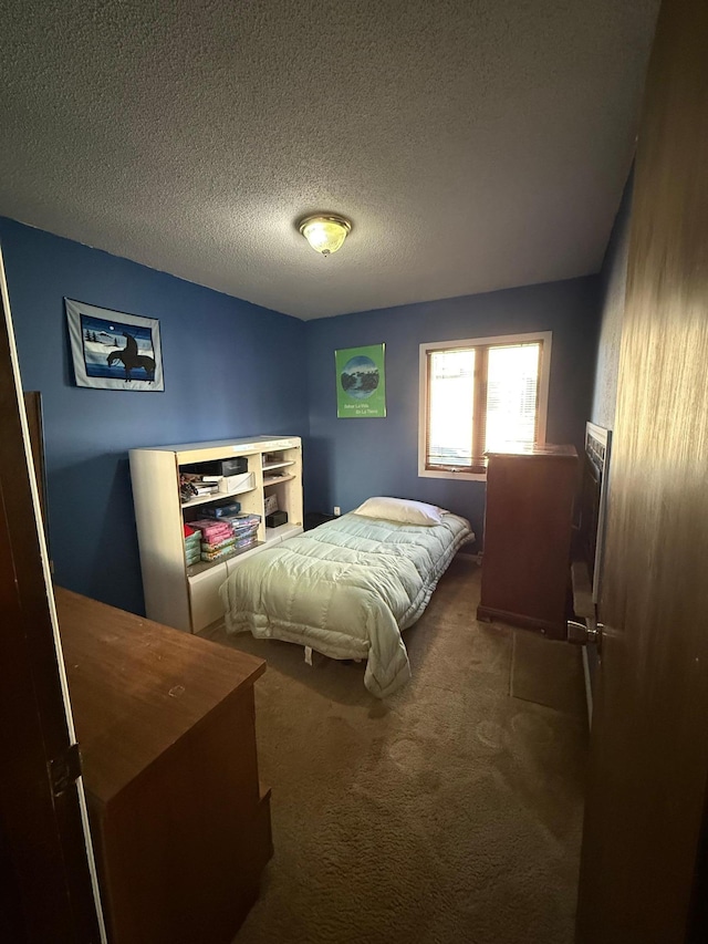 carpeted bedroom featuring a textured ceiling
