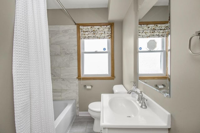 bathroom with toilet, shower / tub combo, a sink, baseboards, and tile patterned floors