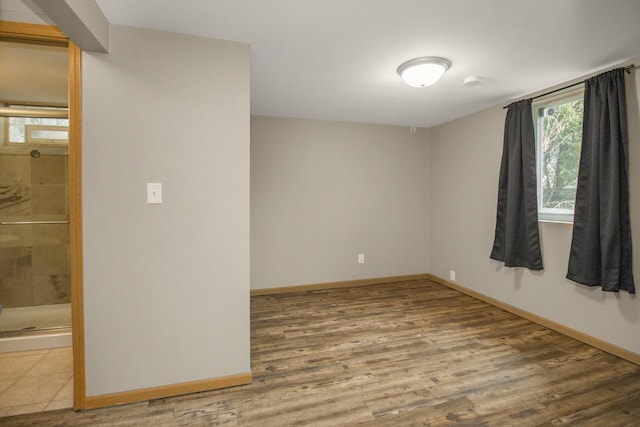 unfurnished room with wood finished floors and baseboards