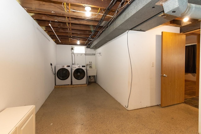 basement featuring a sink and independent washer and dryer