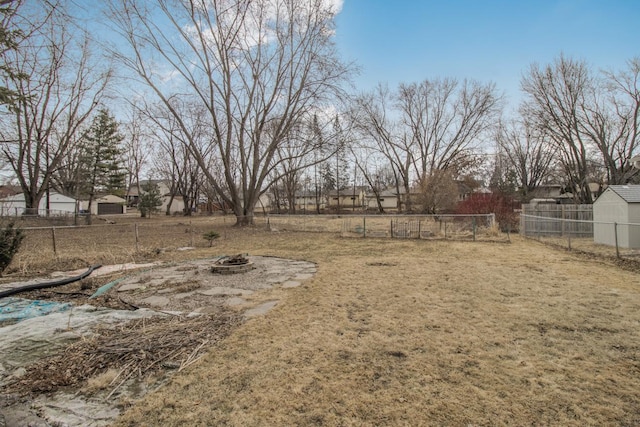 view of yard with an outdoor fire pit and fence