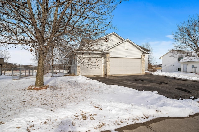 exterior space featuring a garage, brick siding, and fence