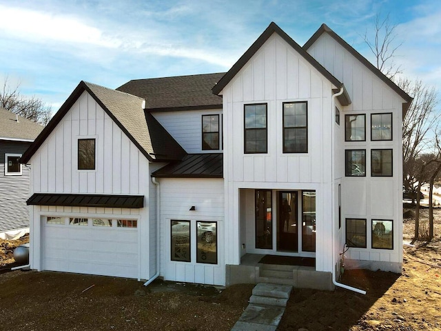 modern inspired farmhouse with a standing seam roof, metal roof, a shingled roof, and board and batten siding