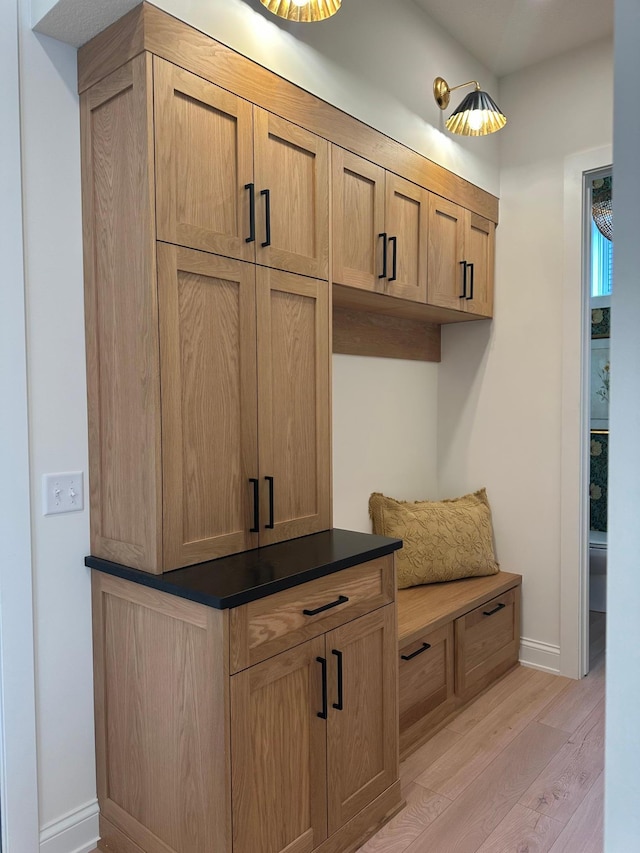 mudroom with baseboards and light wood finished floors