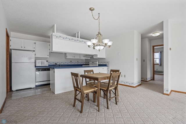 dining area with a baseboard radiator, a textured ceiling, baseboards, and an inviting chandelier