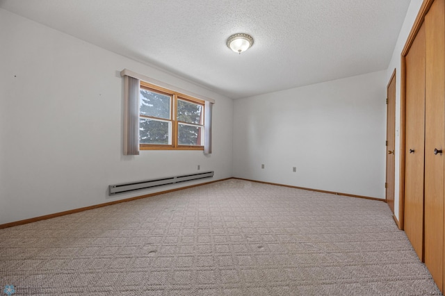 unfurnished bedroom featuring a textured ceiling, a closet, a baseboard radiator, and baseboards