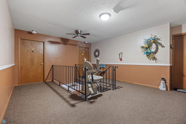 interior space with a textured ceiling and baseboards