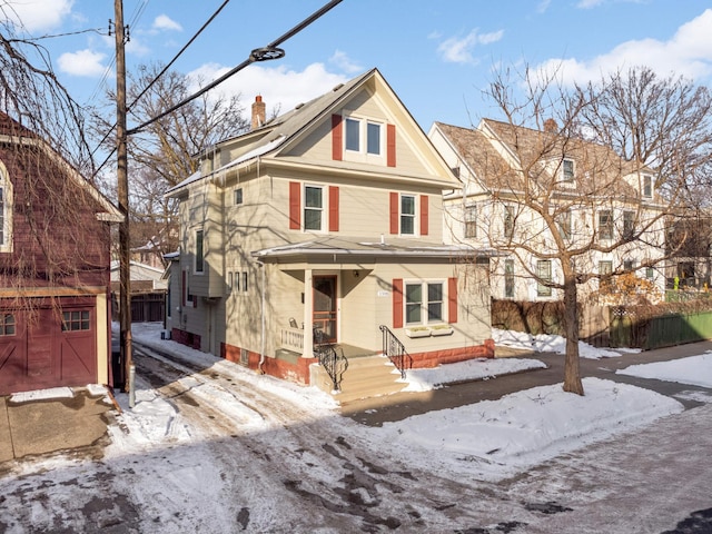 view of front of home with a chimney and fence