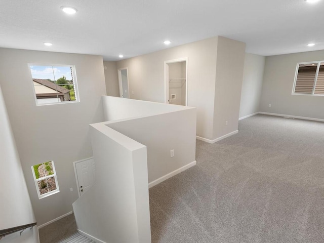 hallway with light colored carpet