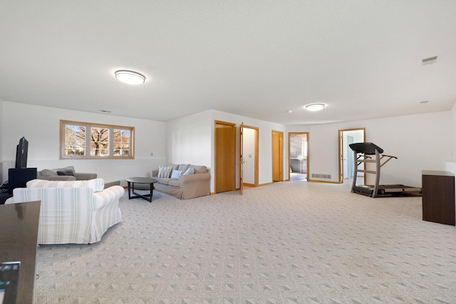 living area with visible vents, baseboards, and light carpet