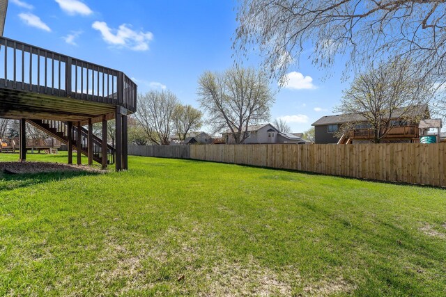 view of yard with stairs, fence private yard, and a deck
