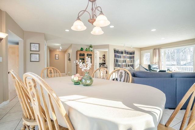 dining room with light tile patterned floors, a notable chandelier, and recessed lighting