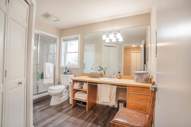 full bathroom with a closet, visible vents, vanity, and toilet