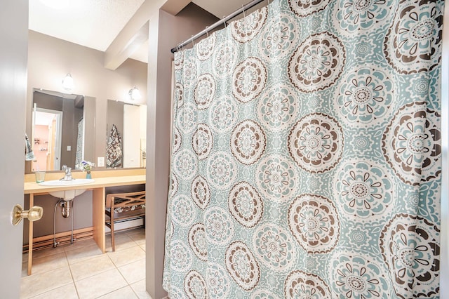 bathroom with tile patterned flooring and a sink