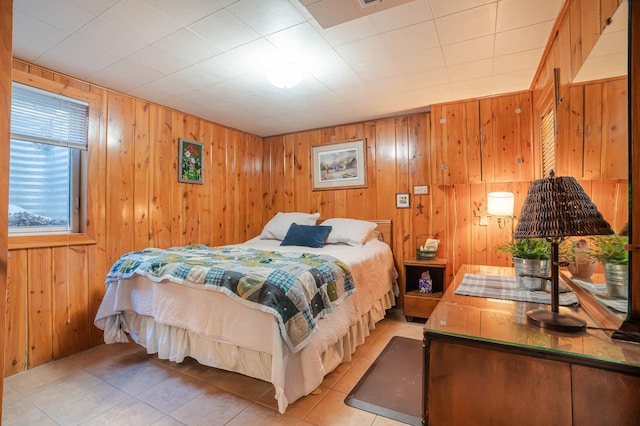 bedroom featuring wood walls