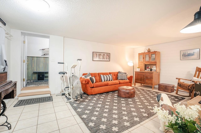 living room featuring a textured ceiling and light tile patterned flooring