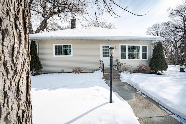 view of front of home featuring a chimney