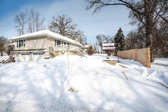 yard covered in snow featuring stairs and fence