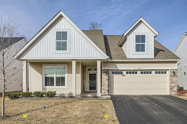 view of front of house featuring aphalt driveway, board and batten siding, and an attached garage