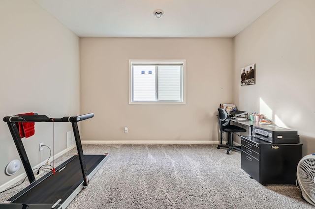 workout room with baseboards and carpet