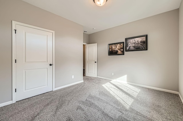 unfurnished bedroom with baseboards and carpet flooring