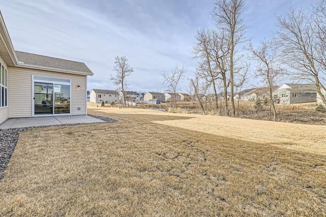 view of yard featuring a patio area and a residential view