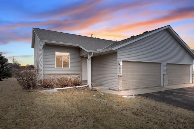 2230 Downing Ave, Shakopee, MN 55379 - view of front of home featuring brick siding, a garage, asphalt driveway, and a shingled roof