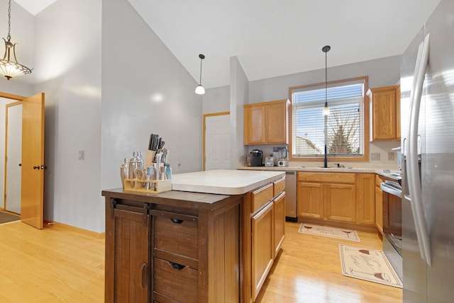 2230 Downing Ave, Shakopee, MN 55379 - kitchen featuring appliances with stainless steel finishes, light wood-style floors, a sink, high vaulted ceiling, and light countertops