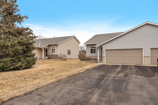 2230 Downing Ave, Shakopee, MN 55379 - view of front of house with driveway, an attached garage, a front lawn, and brick siding