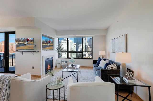 500 Grant St Unit 1302, Minneapolis, MN 55404 - living room with plenty of natural light, baseboards, a glass covered fireplace, and wood finished floors