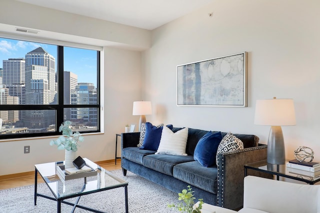 500 Grant St Unit 1302, Minneapolis, MN 55404 - living room with visible vents, a view of city, baseboards, and wood finished floors
