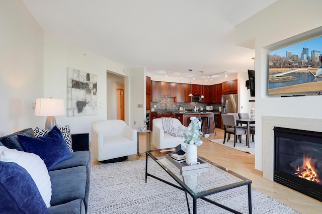 500 Grant St Unit 1302, Minneapolis, MN 55404 - living room featuring light wood-style floors, a glass covered fireplace, and track lighting