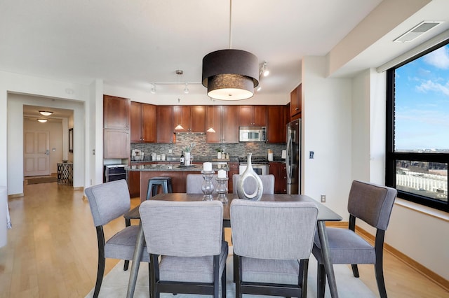 500 Grant St Unit 1302, Minneapolis, MN 55404 - dining space with light wood-type flooring, baseboards, and visible vents