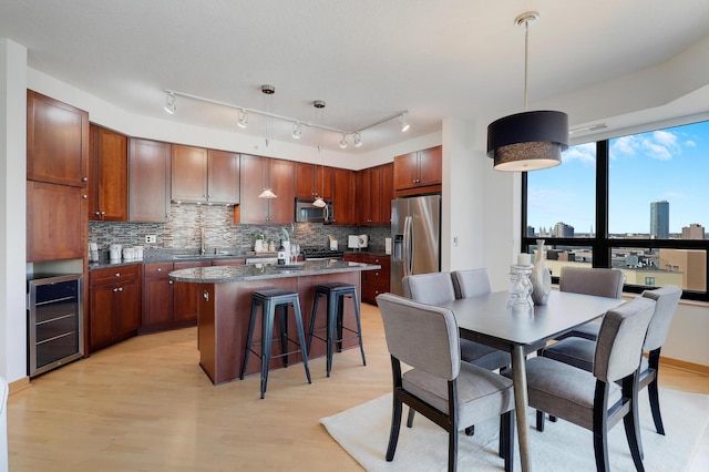 500 Grant St Unit 1302, Minneapolis, MN 55404 - dining space with a view of city, light wood finished floors, and beverage cooler