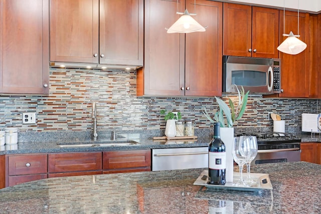 500 Grant St Unit 1302, Minneapolis, MN 55404 - kitchen featuring a sink, dark stone counters, brown cabinetry, and stainless steel appliances
